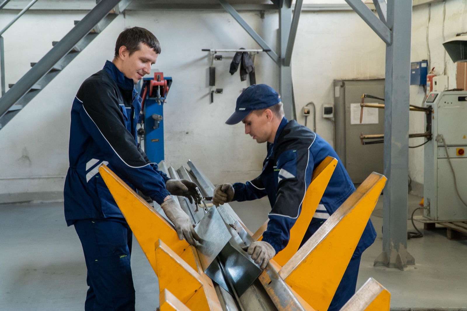 ABL employees make air ducts on a folding machine